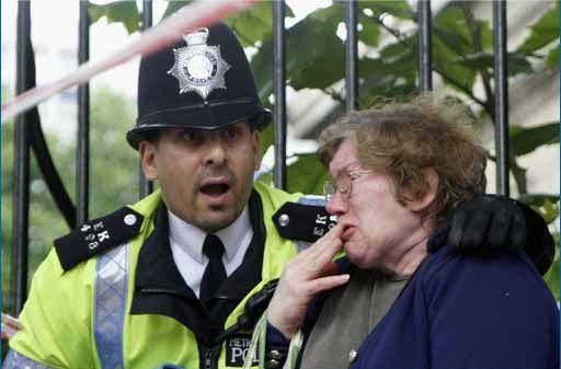 A Policeman consoles a woman near Russell Square tube station